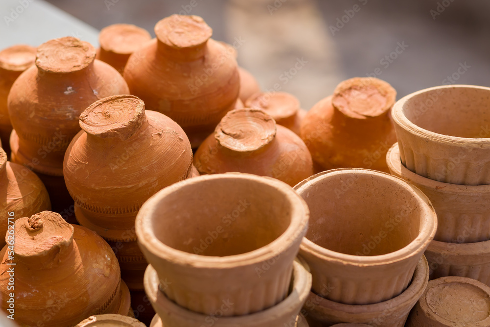 tea cups or pots made of clay kept together. Terracotta pots generally used in tea or coffee shops.