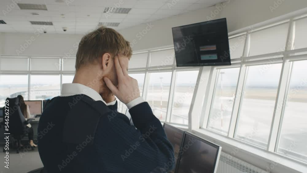 Air traffic control officer having headache working in airport tower. Realtime Air traffic control officer having headache working in airport tower. Realtime