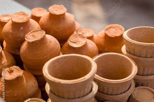 tea cups or pots made of clay kept together. Terracotta pots generally used in tea or coffee shops.