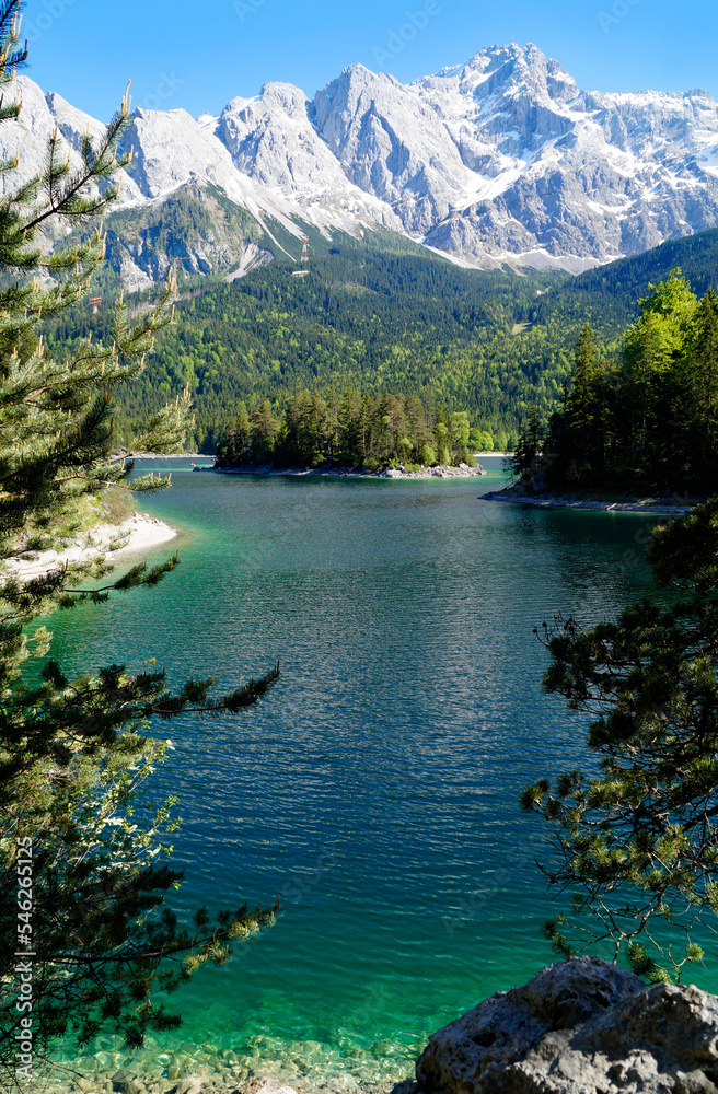 hiking trail overlooking picturesque turquois alpine lake Eibsee (yew lake) by the foot of mountain Zugspitze in the Bavarian Alps (the German Alps, Garmisch-Partenkirchen, Grainau, Bavaria, Germany)