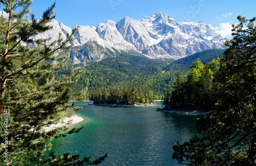 hiking trail overlooking picturesque turquois alpine lake Eibsee (yew lake) by the foot of mountain Zugspitze in Bavaria (the German Alps, Garmisch-Partenkirchen, Grainau, Bavaria, Germany) photo