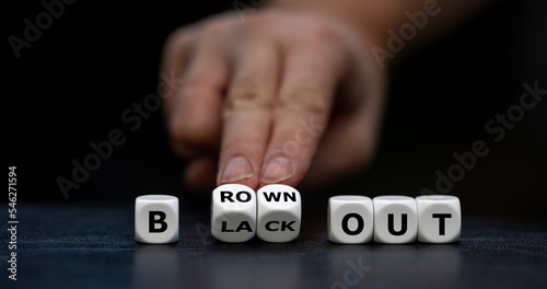 Hand turns dice and changes the expression 'blackout' to 'brownout'.