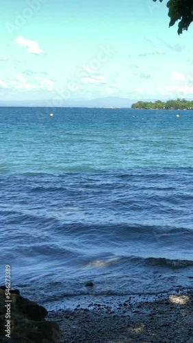 Steady vertical shot of a beautiful beach in a tropical island on a bright windy day, Philippines  photo