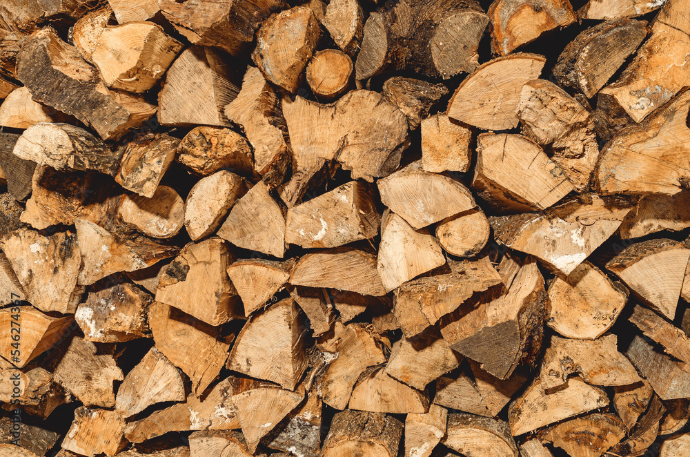 stack of neatly stacked firewood is dried under a canopy in the open air. Background for design. Cover. stack of neatly stacked firewood is dried under a canopy in the open air. Background for design. Cover.