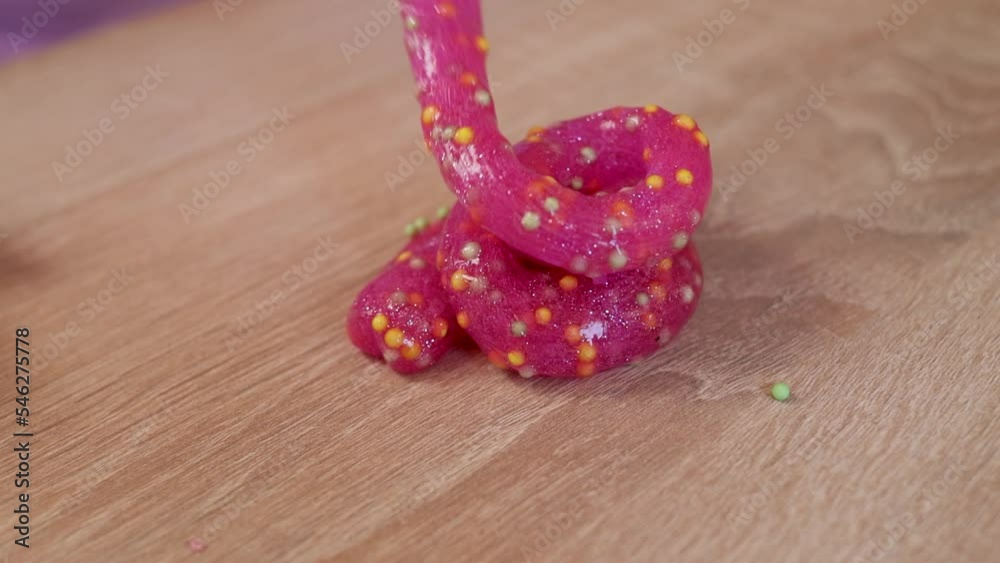 Child playing with colored slime close-up