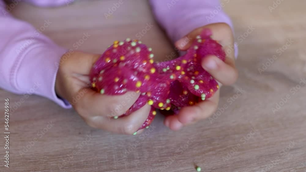 child plays with colored slime on the table. Child development concept