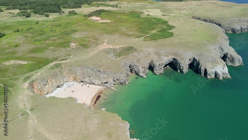 Aerial view of a tiny sandy cove on the Welsh coast photo