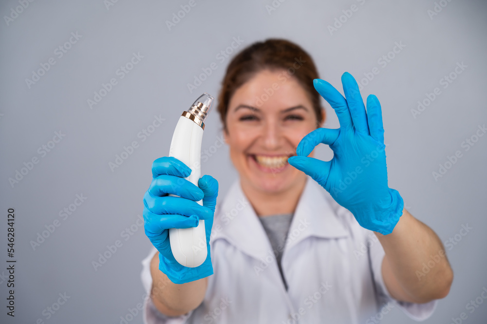 Doctor dermatologist recommends a vacuum skin cleaner at home and shows a sign of ok. Doctor dermatologist recommends a vacuum skin cleaner at home and shows a sign of ok.