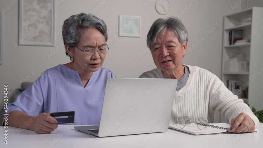 Confused mature Asian couple concerned thinking about online problem looking at laptop, frustrated worried senior people don't understand how use computer with credit card, suffering from memory loss. Confused mature Asian couple concerned thinking about online problem looking at laptop, frustrated worried senior people don't understand how use computer with credit card, suffering from memory loss.