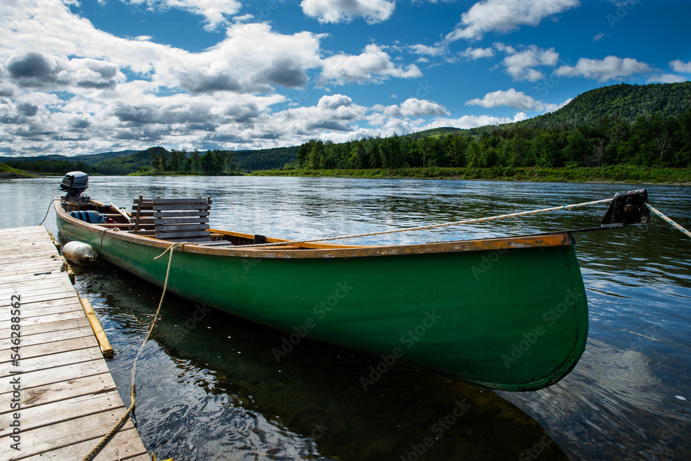 Canoe docked on a river during the summer