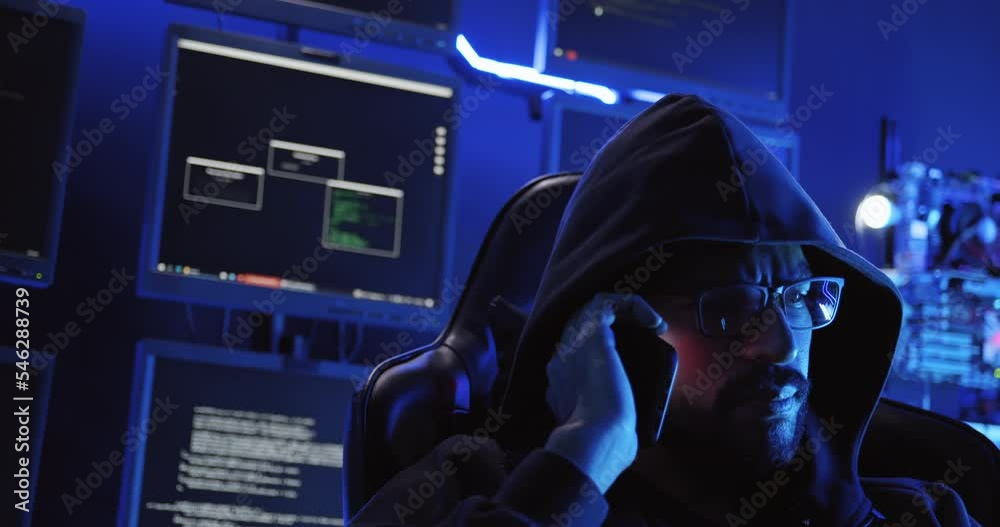 A male hacker is using a computer to hack data to demand ransom from victims. A male hacker is using a computer to hack data to demand ransom from victims.