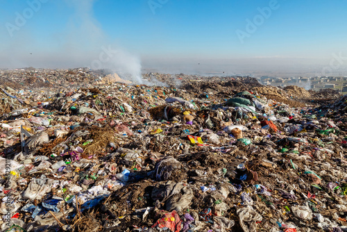 Burning trash piles in landfill