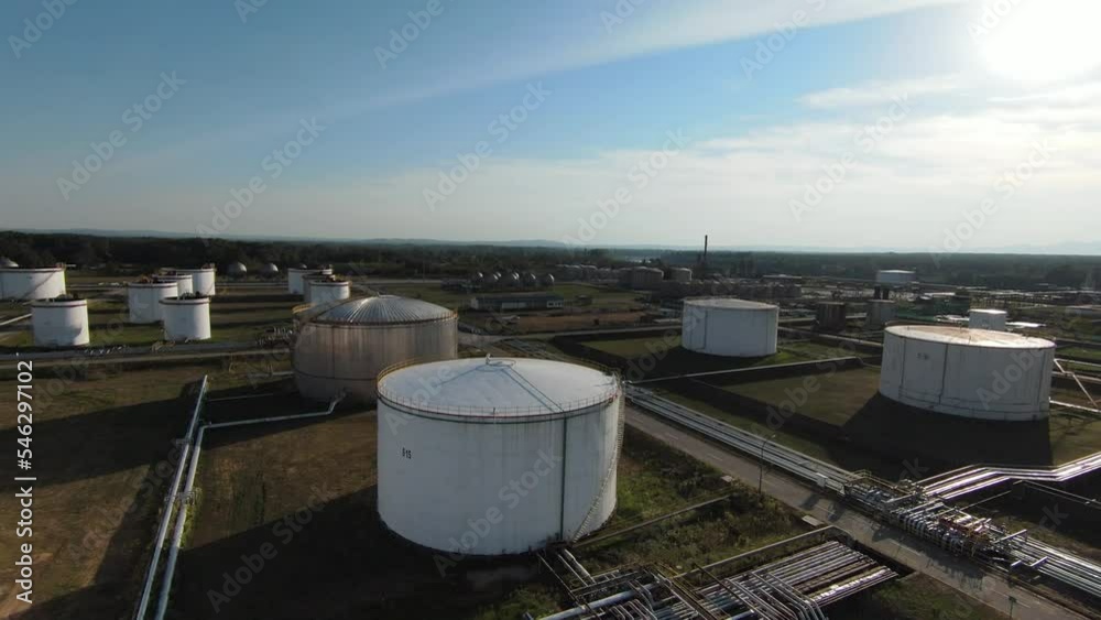 Aerial top down view over oil refinery or chemical factory and power plant with many storage tanks and pipelines. Shot with 4K UHD resolution drone. Aerial top down view over oil refinery or chemical factory and power plant with many storage tanks and pipelines. Shot with 4K UHD resolution drone.
