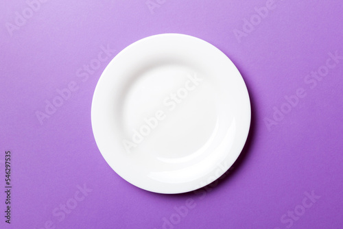 Top view of isolated of colored background empty round white plate for food. Empty dish with space for your design