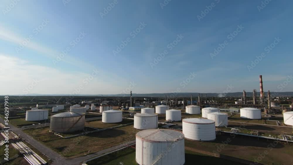 Aerial top down view over oil refinery or chemical factory and power plant with many storage tanks and pipelines. Shot with 4K UHD resolution drone. Aerial top down view over oil refinery or chemical factory and power plant with many storage tanks and pipelines. Shot with 4K UHD resolution drone.