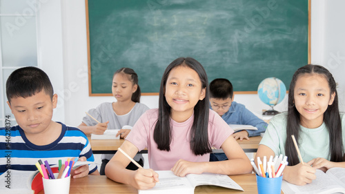 Asian elementary school children learning in classroom