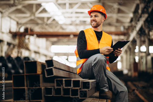 Worker at the steel factory checking the material