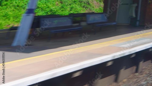 Transport, travel, road, railway, landscape, comnication concept - view from window of speed train on landscape of beautiful nature field road. View on railroad track from the window of fast train photo