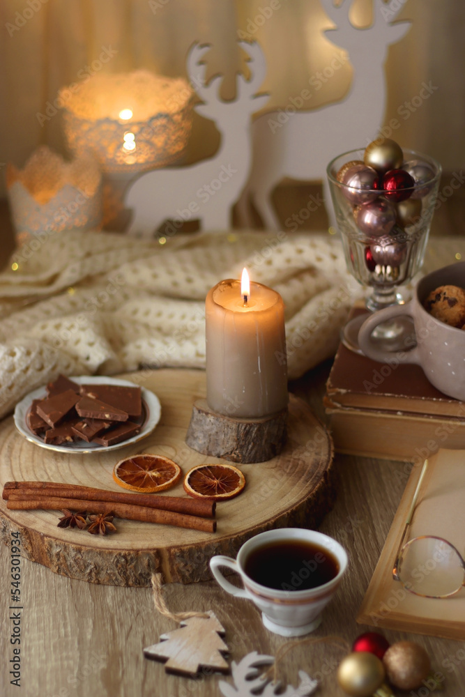 Cup of tea or coffee, various sweets and spices, Christmas decorations, comfy blanket, books and glasses. Selective focus. Cup of tea or coffee, various sweets and spices, Christmas decorations, comfy blanket, books and glasses. Selective focus.