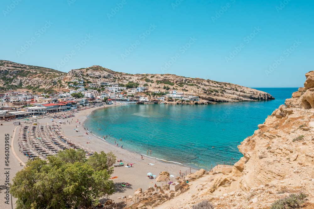matala beach, crete island, greece: sceniv view from famous caves to the beautiful coast and village