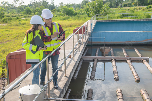 Environmental engineers work at wastewater treatment plants Water supply engineering working at Water recycling plant for reuse Technicians and engineers discuss work together.