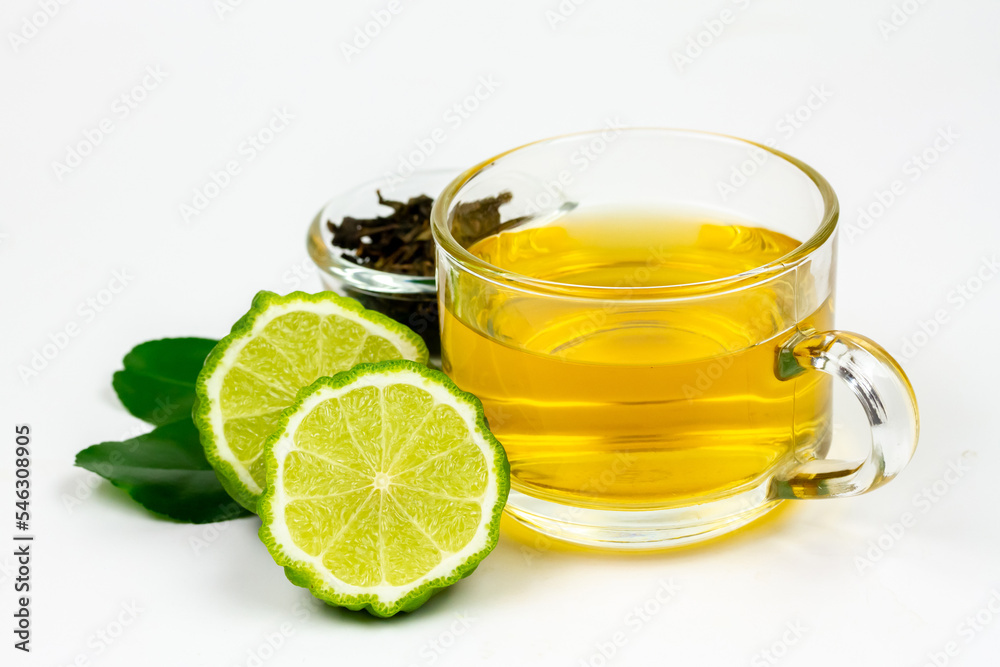 Bergamot tea in transparent cup and fresh bergamot fruit and sliced isolated on white background.