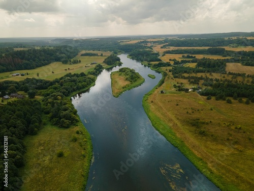 Aerial shot of Neris River in Kernave, Lithuania under a cloudy sky photo