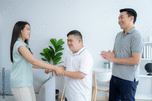 Happy asian family, Parents play and take care of their disabled son at home, Care for the disabled, Down syndrome, Autism.