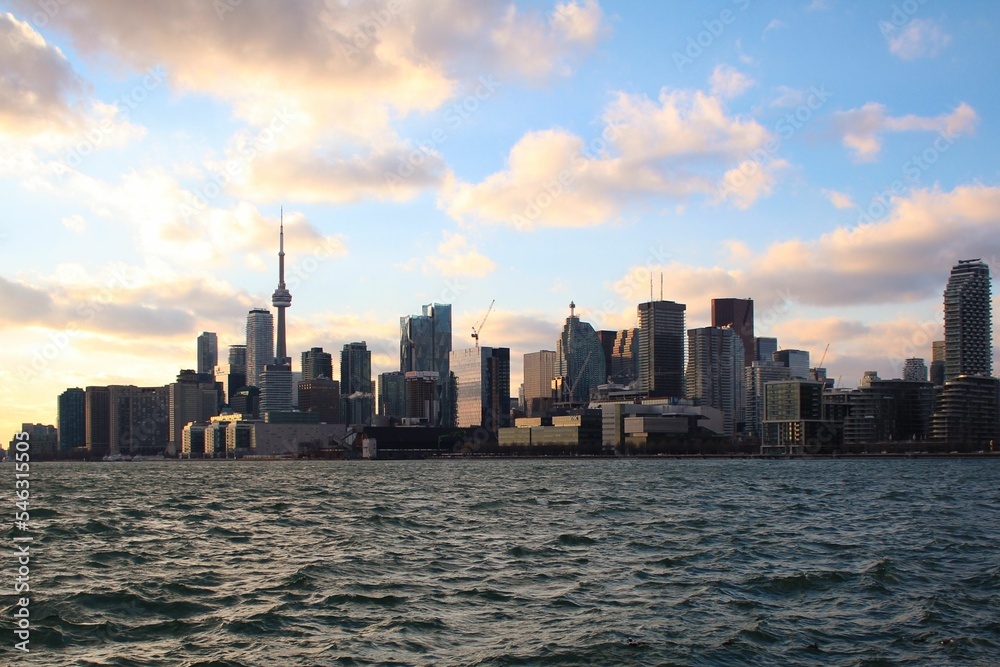 Seascape and coastal city with CN Tower, high buildings and skyscrapers in financial district,Canada
