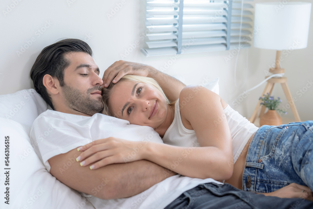 Young Caucasian couples spend their free time together in bedroom at home. Young Caucasian couples spend their free time together in bedroom at home.