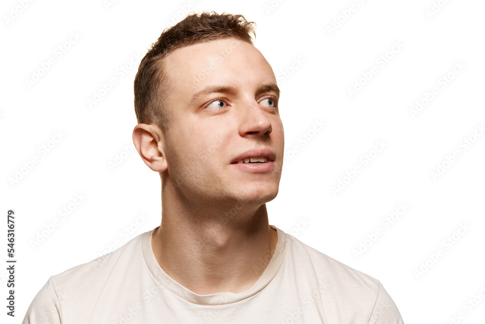 Portrait of young man with smooth shaved face, looking away isolated over white studio background. Concept of men's health, body and skin care Portrait of young man with smooth shaved face, looking away isolated over white studio background. Concept of men's health, body and skin care