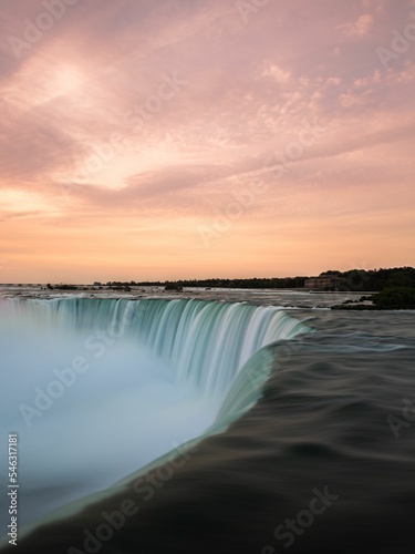 Breathtaking aerial view of Niagara Falls waterfall under colorful sunset sky, long exposure