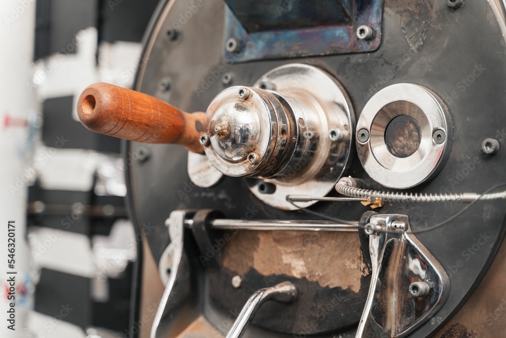 Closeup of a part of coffee roastery equipment with metallic texture