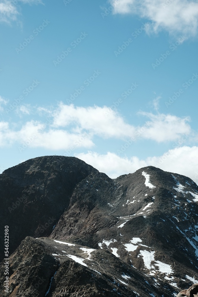 Vertical of Pic D'Estat in Catalonia,Spain under a cloudy blue sky