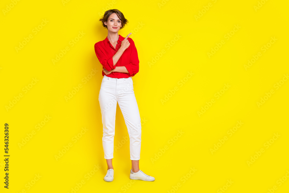 Fototapeta premium Full size portrait of pretty charming girl indicate finger empty space proposition isolated on yellow color background