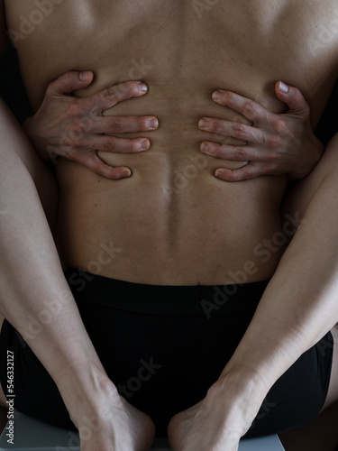 A man and a woman in each other s arms. Women s legs and arms embrace a strong muscular male back. Naked bodies. Photo without a face.