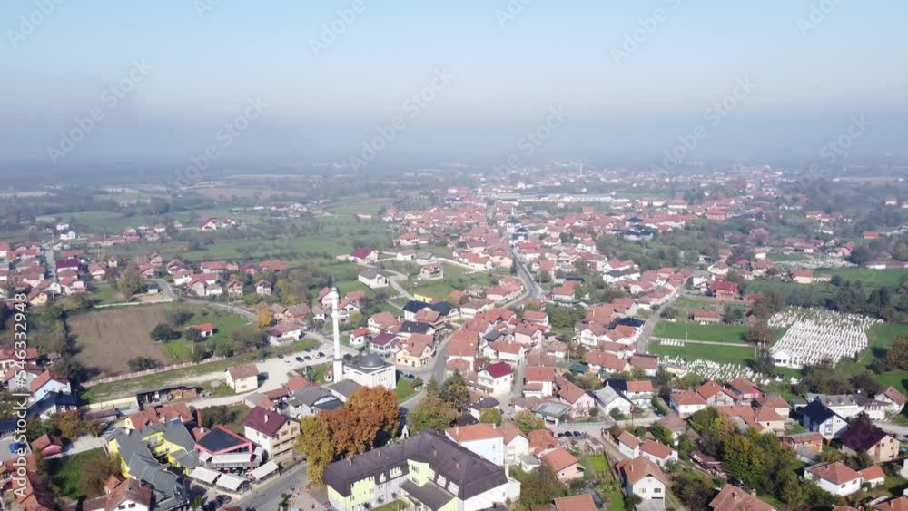 Drone view of houses and parks surrounded by greenery in a suburban area Drone view of houses and parks surrounded by greenery in a suburban area