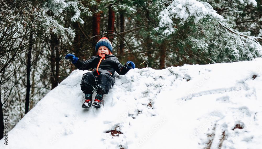 Child riding down a snow hill
