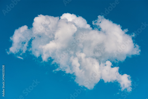 One cumulus cloud against blue background. Single natural formation on serene sky