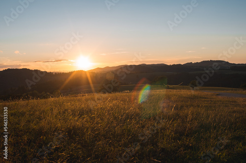 rural sunset in the Black Forest, Southern Germany. natrural sunset over mountains and meadow
