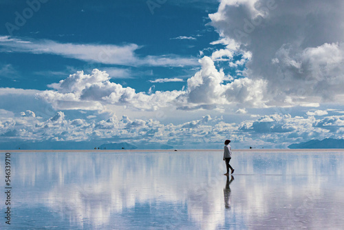 Young man walking through the Salar de Uyuni in Bolivia.