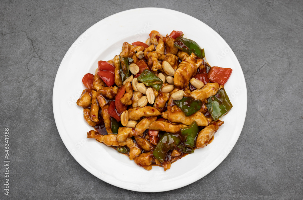 oriental chicken with almonds, chinese traditional food on white plate oriental chicken with almonds, chinese traditional food on white plate