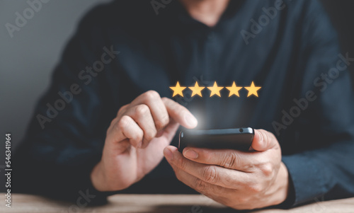 Customers using smartphones give a five-star service rating. Service satisfaction concept, service experience evaluation.