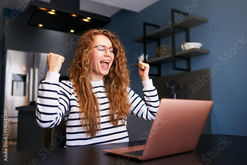Fotografia Happy woman checks e-mail, good news about success on laptop