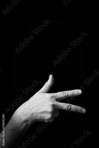 Hand demonstrating the Arabic sign language letter 'غ' or 'Ghayn'