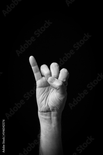Hand demonstrating the Arabic sign language letter 'م' or 'Miem'