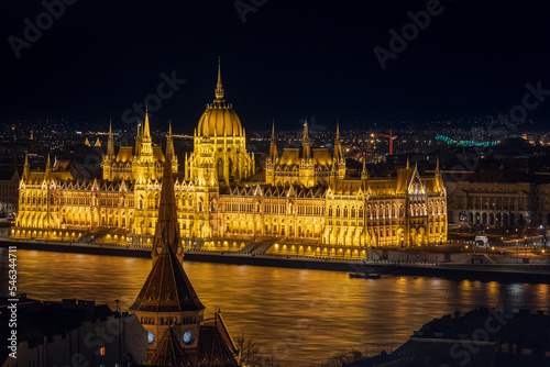 Illuminated Hungarian Parliament Building and Szilágyi Dezső Square Reformed Church. Budapest, Hungary, Eastern Europe.