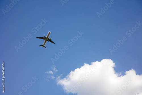 Beautiful Panoramic Background with flying plane in blue sky. Passenger airplane with landing gear released takes off in sky. Travel concept. Wide Angle Wallpaper or Web banner With Copy Space © sorin