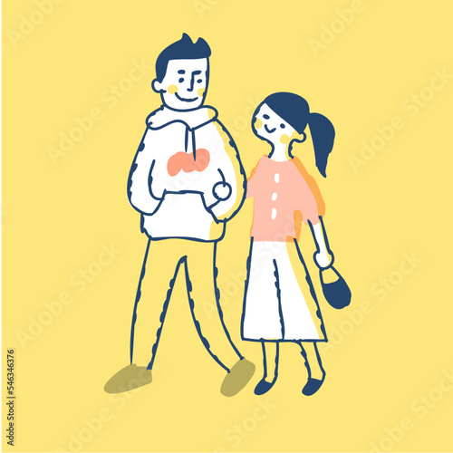 腕を組んで歩く若いカップル