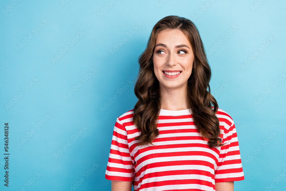 Closeup photo of young attractive adorable nice lady curly hair after salon wear red striped t-shirt looking empty space offer isolated on blue color background Closeup photo of young attractive adorable nice lady curly hair after salon wear red striped t-shirt looking empty space offer isolated on blue color background